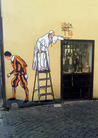 A graffiti depicting Pope Francis and a Swiss guard is seen in Borgo Pio, in Rome, Italy, October 19, 2016. REUTERS/Stringer