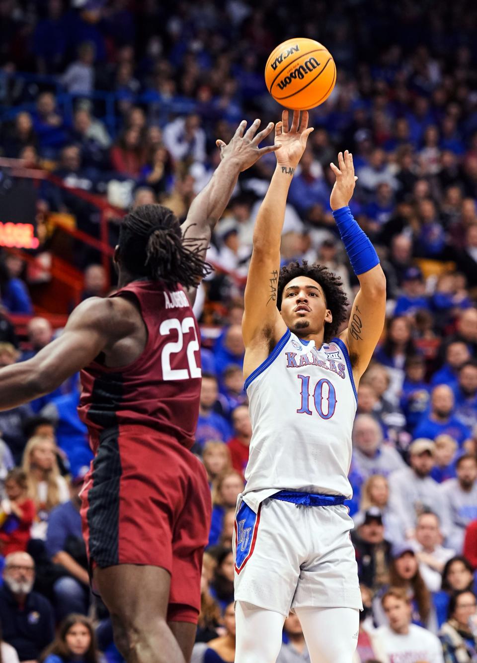 Kansas Jayhawks forward Jalen Wilson (10) shoots over Harvard Crimson forward Justice Ajogbor (22) during the second half Thursday at Allen Fieldhouse.