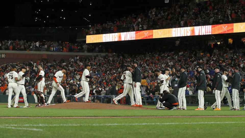 San Francisco Giants players celebrate after defeating the Los Angeles Dodgers in Game 1 of a baseball National League Division Series Friday, Oct. 8, 2021, in San Francisco. (AP Photo/John Hefti)