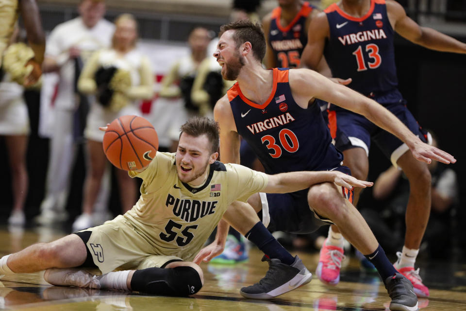 Purdue guard Sasha Stefanovic (55) is fouled by Virginia forward Jay Huff (30) during the first half of an NCAA college basketball game in West Lafayette, Ind., Wednesday, Dec. 4, 2019. (AP Photo/Michael Conroy)
