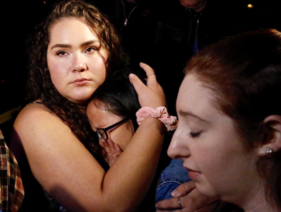 Nellie Wong cries as Chyann Worrell holds her. The two and Erika Sigman (right) were all inside when the&nbsp;shooting started inside the Borderline Bar &amp; Grill.