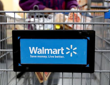 FILE PHOTO: A customer pushes a shopping cart at a Walmart store in Chicago, Illinois, U.S. November 23, 2016. REUTERS/Kamil Krzaczynski/File Photo