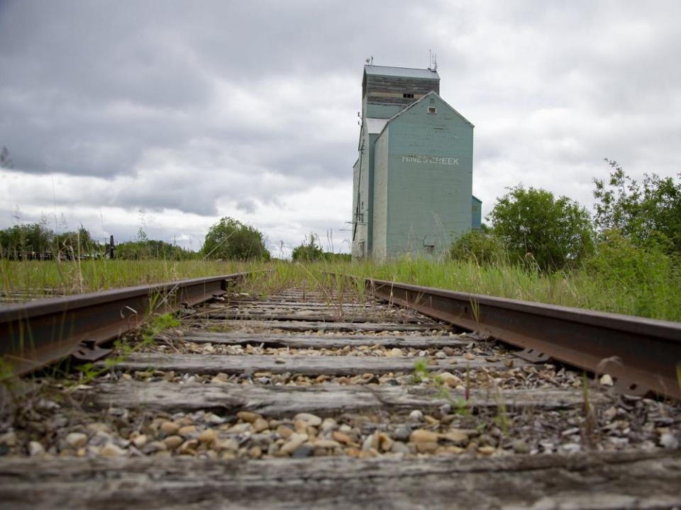  Railroad tracks by a grain elevator in Alberta.