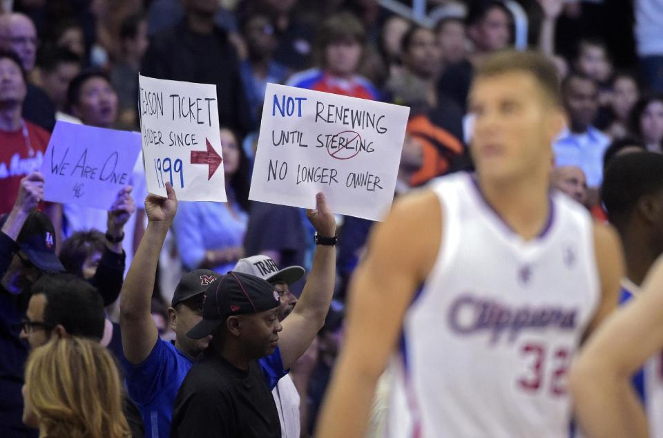 Fans hold up signs as Los Angeles Clippers forward Blake Griffin looks on during the second half in Game 5 of an opening-round NBA basketball playoff series against the Golden State Warriors, Tuesday, April 29, 2014, in Los Angeles. The Clippers won 113-103. (AP Photo)