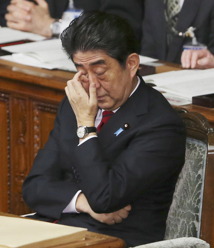 Japanese Prime Minister Shinzo Abe scratches his nose as he attends the opening diet session after delivering a speech calling for a dialogue between Japan and neighbors, China and South Korea, to improve stalled diplomatic relations, at the lower house of Parliament in Tokyo, Friday, Jan. 24, 2014. China said Friday it has begun issuing warnings to foreign military planes entering its self-declared air defense zone over the East China Sea amid heightened tensions with its neighbors, especially Japan. (AP Photo/Koji Sasahara)
