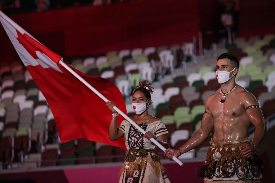 Pita Taufatofua  could be seen topless while waving his country’s flag (AFP via Getty Images)