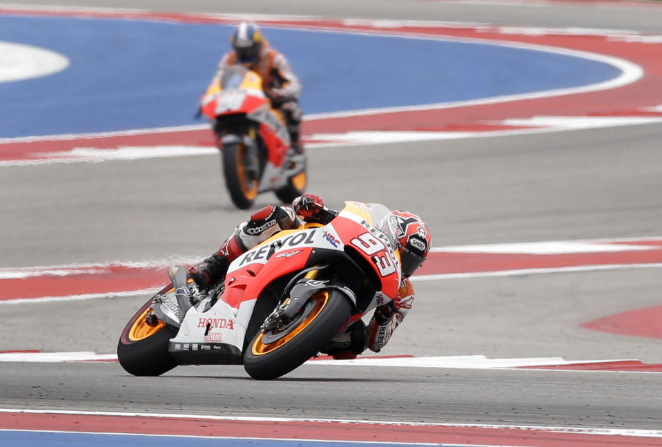 Marc Marquez of Spain comes out of Turn 5 as his teammate Dani Pedrosa (26) of Spain follows behind during the Grand Prix of the Americas MotoGP motorcycle race, Sunday, April 13, 2014, in Austin, Texas. Marquez won the race with Pedrosa finishing in second place. (AP Photo/Tony Gutierrez)