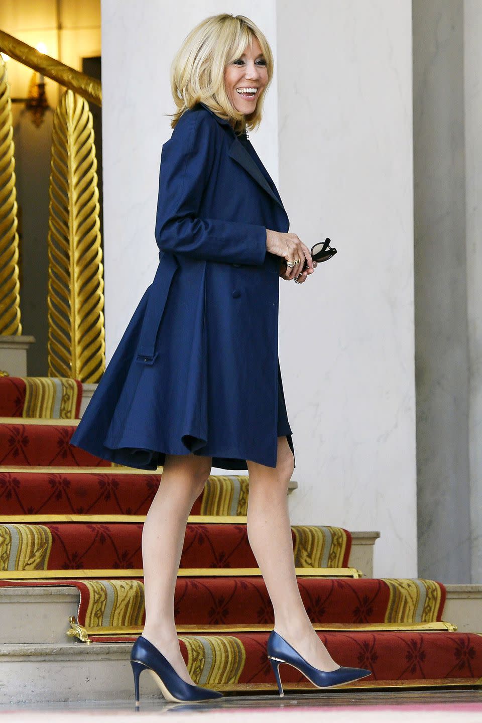 <p>Leaving the Elysee Palace in a navy dress, coat, and matching heels. </p>