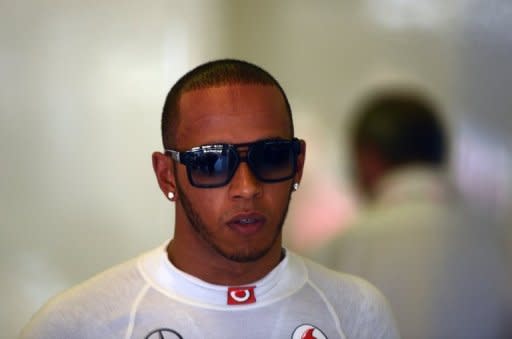 McLaren Mercedes' British driver Lewis Hamilton stands in the pits at the Hungaroring circuit on July 27. Hamilton set the pace in treacherous conditions on Friday, topping times in both opening practice sessions ahead of this weekend's Hungarian Grand Prix, the last race before Formula One's mid-season break