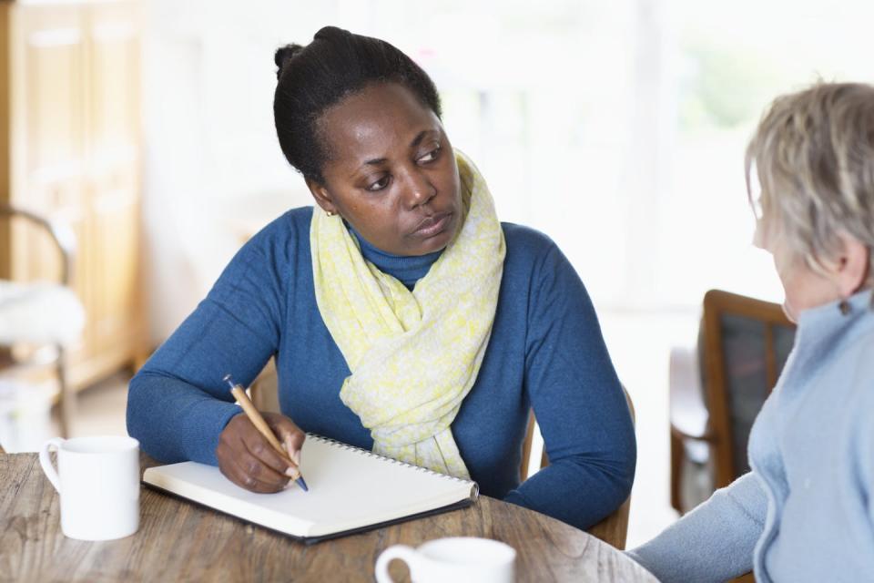 A Black social worker listens to a client. <a href="https://www.gettyimages.com/detail/photo/social-worker-meeting-a-client-royalty-free-image/532120326?phrase=black%20social%20workers&adppopup=true" rel="nofollow noopener" target="_blank" data-ylk="slk:Silvia Jansen/Getty Images;elm:context_link;itc:0;sec:content-canvas" class="link ">Silvia Jansen/Getty Images</a>