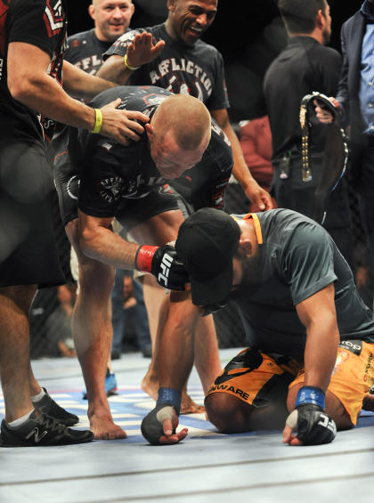 GSP tried to console Johny Hendricks after the decision was read. (USA Today)