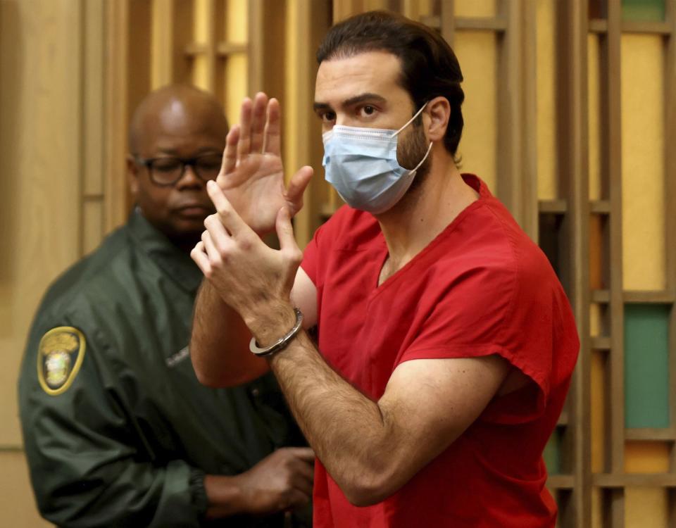 Pablo Lyle, gestures toward family members as he leaves the courtroom after Judge Maria Tinkler Mendez ruled against a new trial Lyle as he, his family, lawyers, and members of the media gathered in Courtroom 4-6 at the Richard E. Gerstein Justice Building in Miami, Fla. on Monday, Dec. 12, 2022. (Carl Juste/Miami Herald via AP)