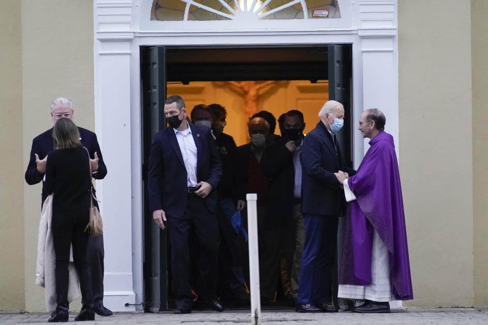 President Joe Biden talks with Monsignor John Hopkins as he leaves St. Joseph on the Brandywine Catholic Church in Wilmington, Del., Saturday, Dec. 18, 2021. (AP Photo/Carolyn Kaster)