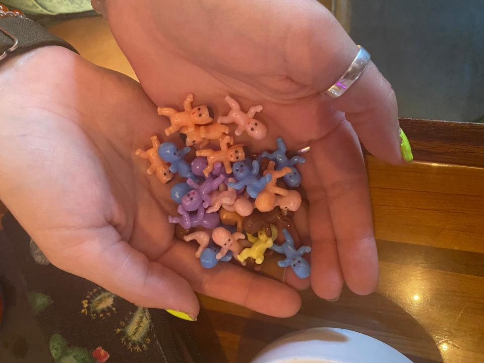 Julia Smith reveals some of the tiny plastic babies that she has been hiding around the New Bedford area.