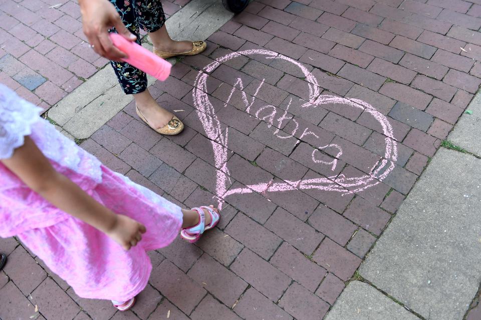 Nabra Hassanen's name appears in chalk at a vigil at on&nbsp;June 21 near Reston, Virginia. (Photo: The Washington Post via Getty Images)