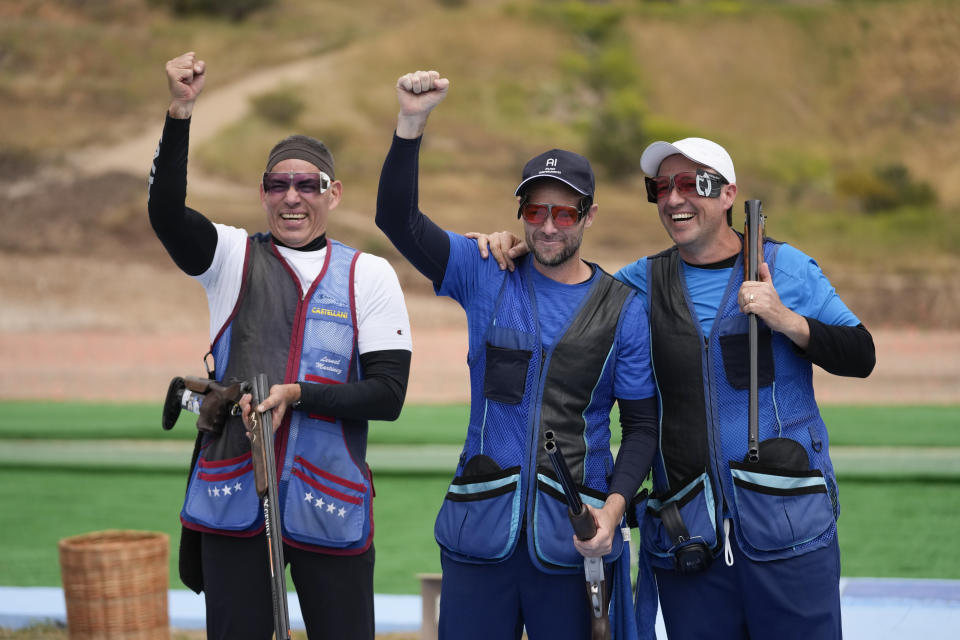 FILE - Silver medalist Venezuelan Leonel Martinez, from left, gold medalist Guatemalan Jean Pierre Brol and bronze medalist Guatemalan Herbert Brol pose at the end of their men's trap shooting event at the Pan American Games in Santiago, Chile, Oct. 27, 2023. Martinez was only 20 years old when he took part in the Los Angeles Games in 1984, but says he’s in better shape now, at 60, as he prepares to compete in Paris after the second-longest gap between Olympic appearances in history. (AP Photo/Moises Castillo, File)