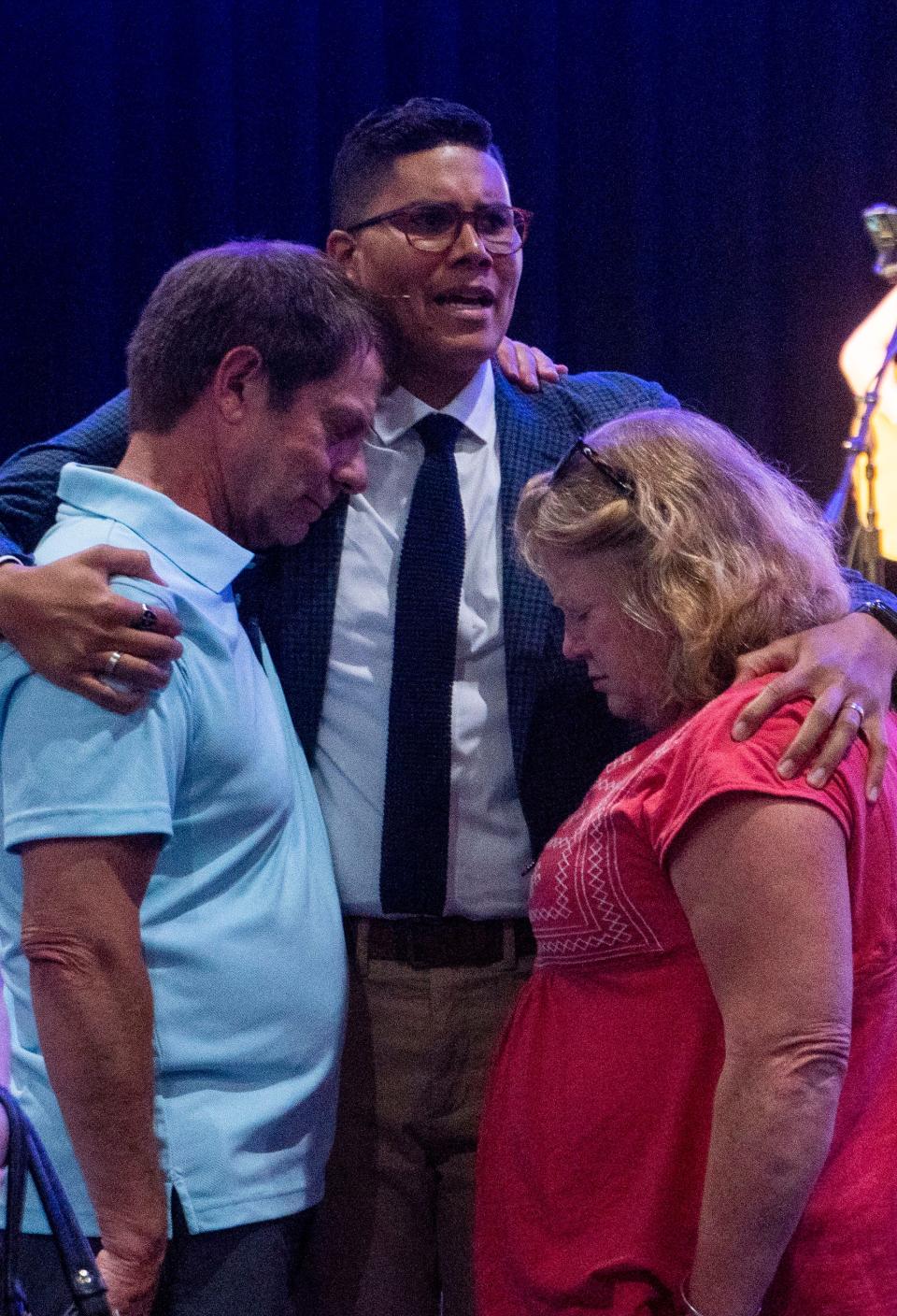 Pastor Geroge Matthew Clash, in center, praying with Brian Seley, Katie Seley's father, on left, and Donna Altman, on right, after the prayer vigil for the victims of the recent flooding in Upper Makefield at the Washington Crossing United Methodist Church in Washington Crossing on Thursday, July 20, 2023.