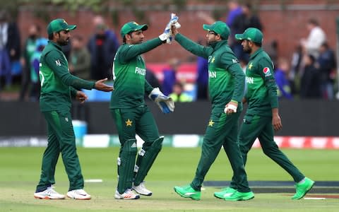 Pakistan players celebrate the wicket of Australia's David Warner - Credit: PA