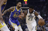 Utah Jazz forward Royce O'Neale, right, drives the ball against Golden State Warriors' D'Angelo Russell (0) in the first half of an NBA basketball game Wednesday, Jan. 22, 2020, in San Francisco. (AP Photo/Ben Margot)