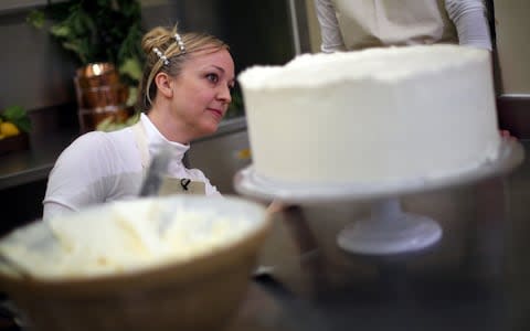 Claire Ptak, Owner of Violet Bakery in Hackney, east London puts finishing touches on the cake for the Royal Wedding of Prince Harry and Meghan Markle - Credit: Getty