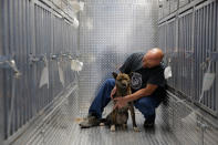 <p>Pittsburgh Aviation Animal Rescue Team (PAART) volunteer David Manko sits on board PAART’s Transport Trailer with a dog rescued from a South Korean dog meat farm by Humane Society International (HSI) on Sunday, March 26, 2017, in New York. HSI reached an agreement with the farmers to permanently close the farm and fly all the dogs to the United States for adoption. This is the seventh dog meat farm the organization has closed in South Korea so far, saving more than 800 dogs as part of its campaign across Asia to end the killing of dogs for consumption. (Andrew Kelly/AP Images for Humane Society International) </p>