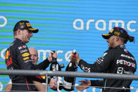 Red Bull driver Max Verstappen, left, of the Netherlands, and Mercedes driver Lewis Hamilton, right, of Britain, celebrate on the podium after the Formula One U.S. Grand Prix auto race at Circuit of the Americas, Sunday, Oct. 23, 2022, in Austin, Texas. Verstappen won the race and Hamilton finished second. (AP Photo/Charlie Neibergall)