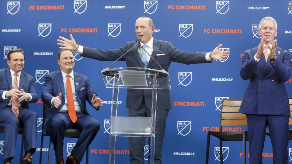 Major League Soccer commissioner Don Garber, center, officially announces the addition of FC Cincinnati as an expansion team, alongside Cincinnati Mayor John Cranley, left, FC Cincinnati general manager and president Jeff Berding, center left, and FC Cincinnati owner Carl Lindner III, right, Tuesday, May 29, 2018, at Rhinegeist Brewery in Cincinnati. (AP Photo/John Minchillo)