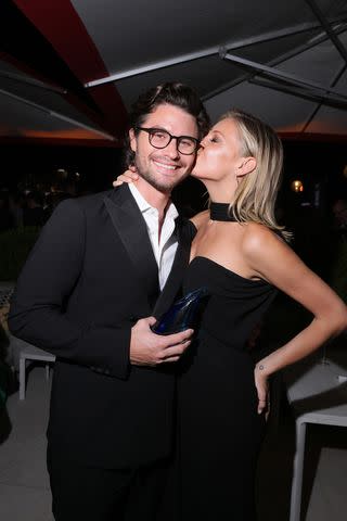 <p>Victor Boyko/Variety via Getty</p> Kelsea Ballerini plants a kiss on boyfriend Chase Stokes' cheek at the Variety Golden Globes Party at the 2023 Venice Film Festival