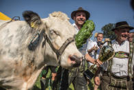 <p>Participant Michael Pfatrisch wearing traditional Bavarian lederhosen celebrates winning in the 2016 Muensing Oxen Race (Muensinger Ochsenrennen) with his ox Baze on August 28, 2016 in Muensing, Germany. (Photo: Matej Divizna/Getty Images)</p>