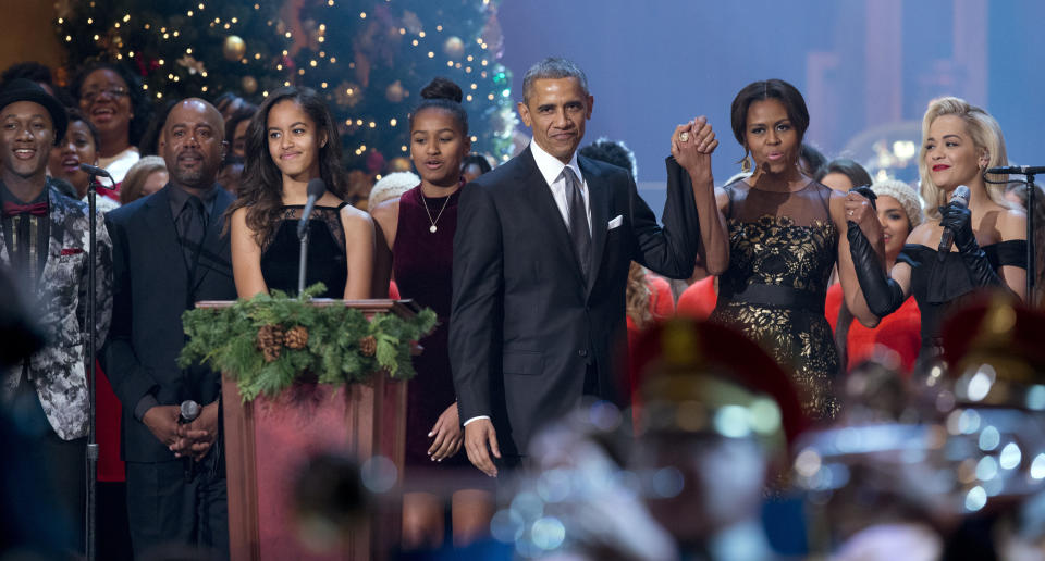 The first family -- Malia Obama, Sasha Obama, President Barack Obama, and first lady Michelle Obama -- join performers Aloe Blacc, Darius Rucker and Rita Ora on the stage during the taping of the annual 2014 Christmas in Washington presentation at the National Building Museum in Washington, Sunday, Dec. 14, 2014.