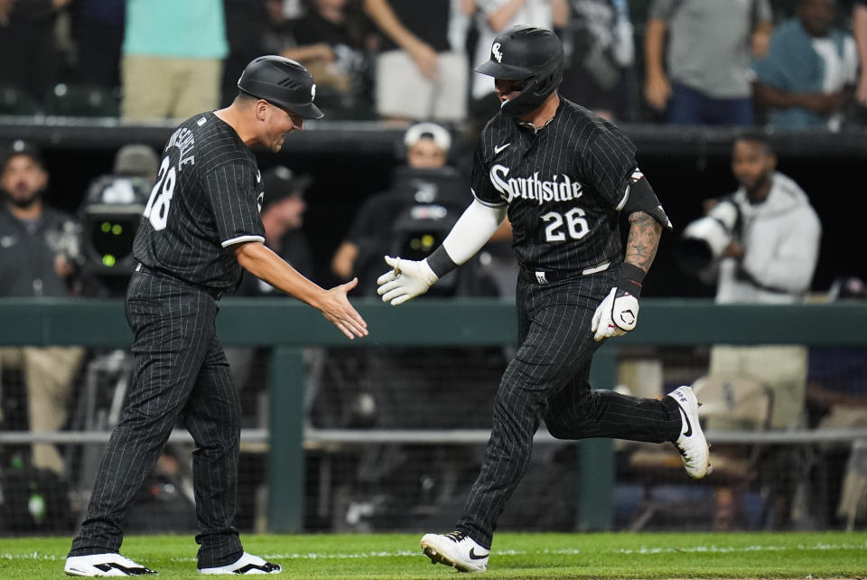 Chicago White Sox's Korey Lee, right, slaps hands with third base coach Justin Jirschele, left, as he runs the bases on a home run during the fourth inning of a baseball game against the New York Yankees, Monday, Aug. 12, 2024, in Chicago. (AP Photo/Erin Hooley)