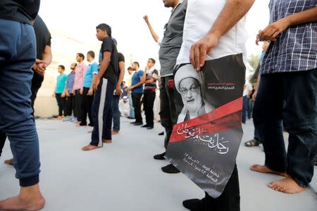 A supporter holds photo of Bahrain's leading Shi'ite cleric Isa Qassim during a sit-in outside his home in the village of Diraz west of Manama, Bahrain June 21, 2016. REUTERS/Hamad I Mohammed