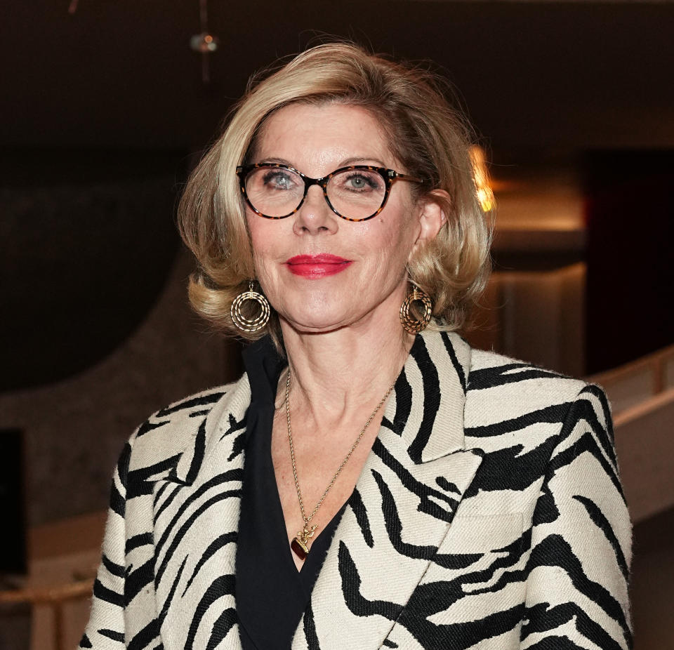 closeup of her in a zebra print blazer and wearing glasses