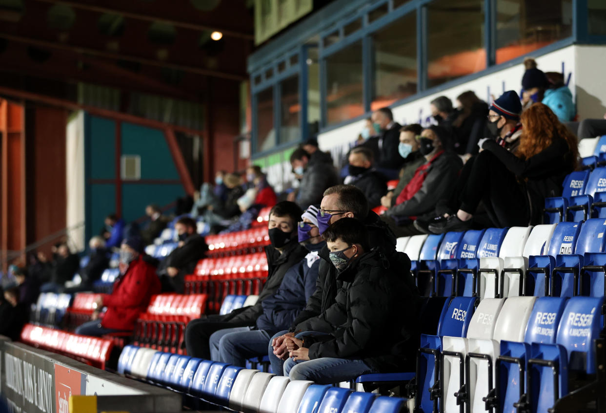 Fans in PPE in the stands before the Scottish Premiership match at the Global Energy Stadium, Dingwall.