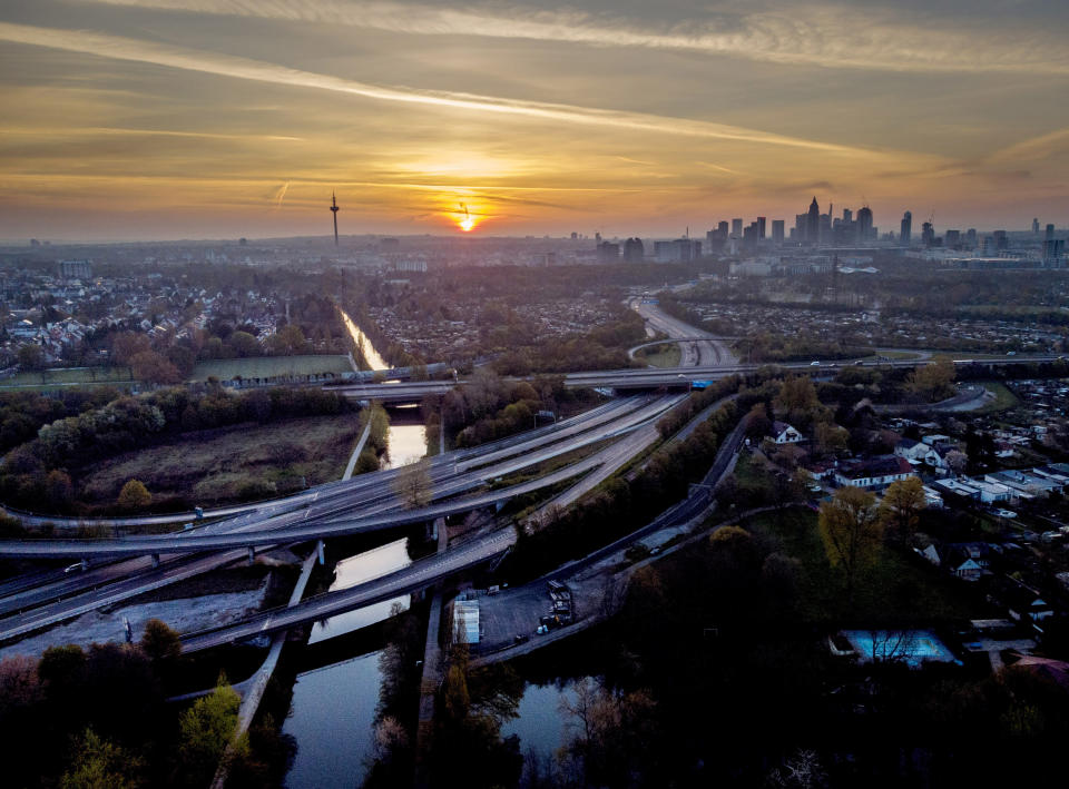 Almost empty highways lead to Frankfurt, Germany, as the sun rises on Saturday, April 24, 2021. From the weekend on a curfew becomes effective to avoid the outspread of the coronavirus. (AP Photo/Michael Probst)