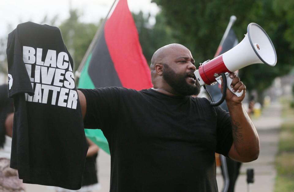 Franklin Ragsdale uses a bullhorn during a protest at Summit County Jail on Tuesday in response to the shooting death of Jayland Walker by Akron police.