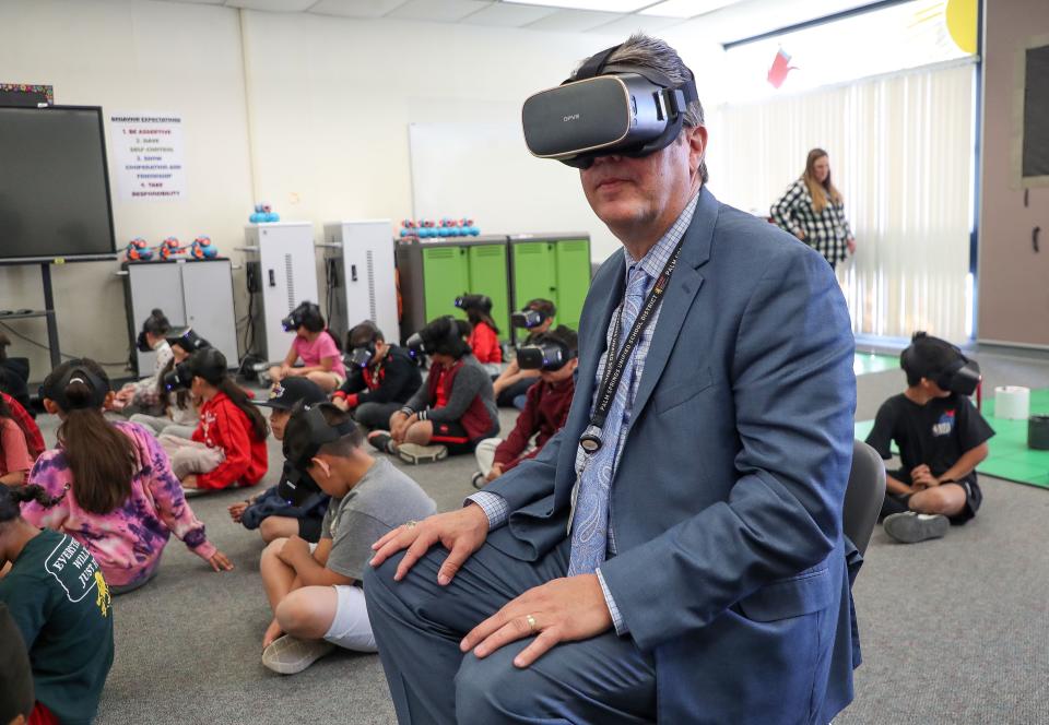 Palm Springs Unified School District superintendent Tony Signoret checks out a VR headset in a VR class at Landau Elementary School in Cathedral City, Calif., Dec. 12, 2023.