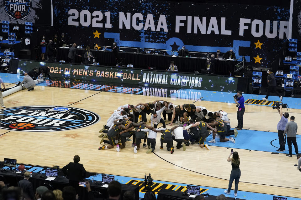 FILE - Baylor players huddle on the court at the end of the championship game against Gonzaga in the men's Final Four NCAA college basketball tournament in Indianapolis, in this Monday, April 5, 2021, file photo. A law firm hired to investigate gender equity concerns at NCAA championship events released a blistering report Tuesday, Aug. 3, 2021, that recommended holding the men's and women's Final Fours at the same site and offering financial incentives to schools to improve their women's basketball programs. (AP Photo/Darron Cummings, File)