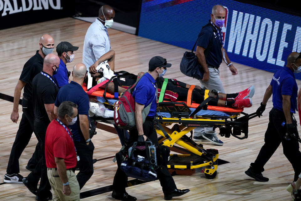 Miami Heat's Derrick Jones Jr is carried off the court on a stretcher after being injured against the Indiana Pacers during the second half of an NBA basketball game Monday, Aug. 3, 2020, in Lake Buena Vista, Fla. (AP Photo/Ashley Landis, Pool)