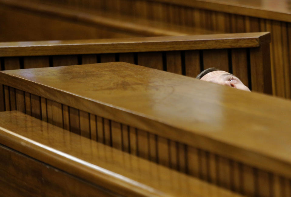 Oscar Pistorius leans back after applying eye drops in court in Pretoria, South Africa, Friday, March 14, 2014. Pistorius is charged with the shooting death of his girlfriend Reeva Steenkamp, on Valentines Day in 2013. (AP Photo/Kim Ludbrook, Pool)
