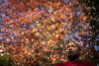 Troy Currence, 48, a medicine man from the Herring Pond Wampanaoag Tribe, stands for a portrait outside his home in Bourne, Mass., Monday, Sept. 21, 2020. Currence says he's hopeful that the attention on the problem of systemic racism this year will help their voices and stories be heard in a way they haven't been before. "It's opening up everyone else's eyes to how unbalanced the world is and unequal," he said. The world is spinning out of control. So I think more people are going to be aware and more sensitive and open to receiving a message like that." (AP Photo/David Goldman)