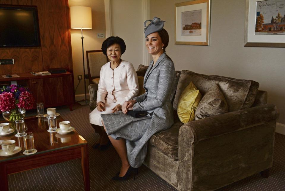 Britain's Catherine, Duchess of Cambridge sits with Mary Chee, the wife of the President of Singapore Tony Tan, in London