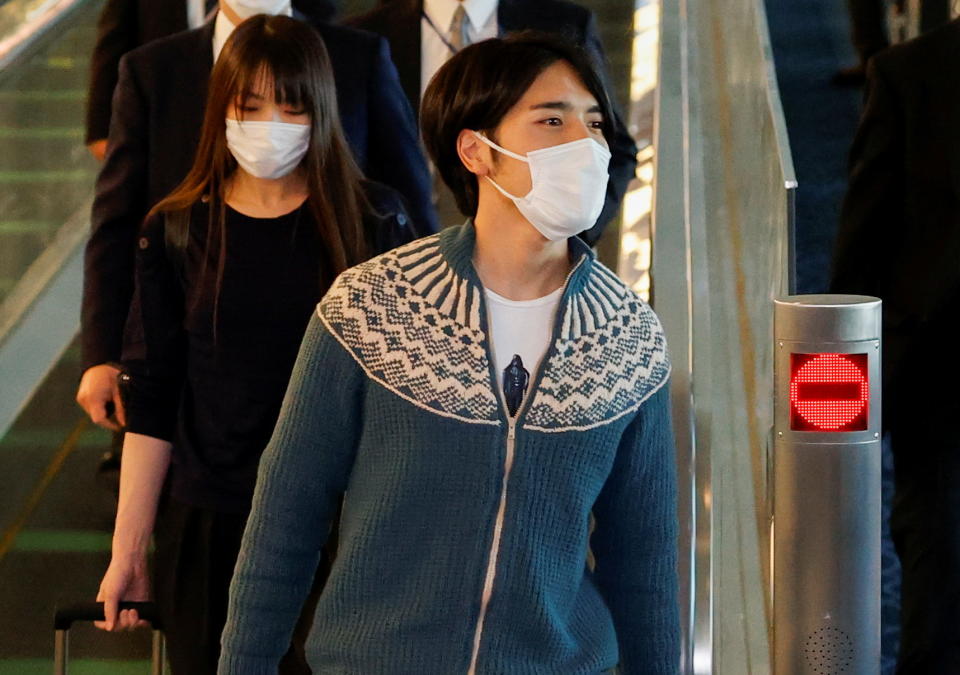 Mako Komuro, former Japan's Princess Mako and the eldest daughter of Crown Prince Akishino and Crown Princess Kiko, and her newly married husband Kei are pictured before they board a flight bound for New York to start their new life in the U.S. at Haneda airport in Tokyo, Japan November 14, 2021.  REUTERS/Issei Kato