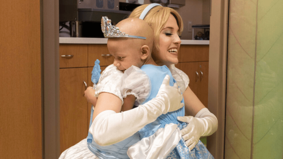 Cinderella shares a hug with Ivori in our pediatric hematology-oncology clinic. (HSHS St. Vincent Children's Hospital)