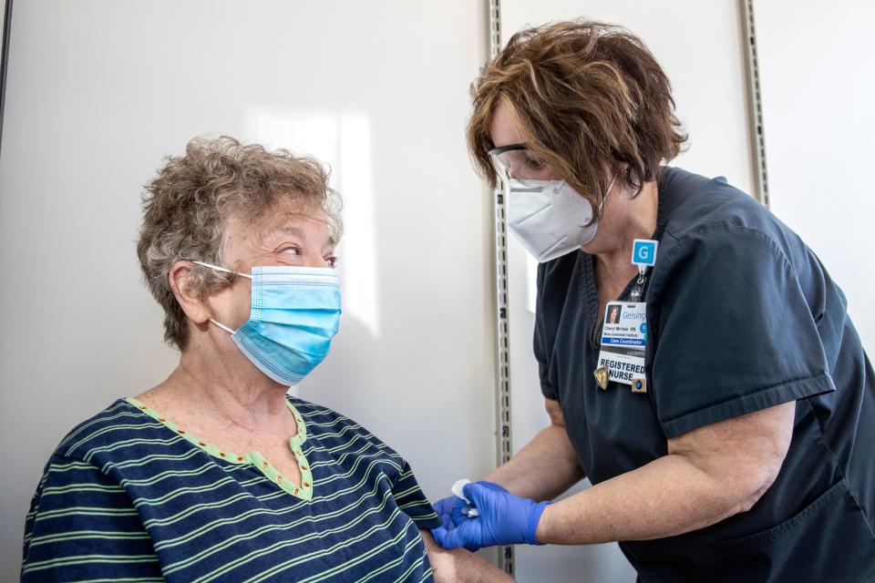 Eleanor Leisenring speaks with Cheryl McHale, RN, after receiving the COVID-19 vaccine at a Geisinger community vaccine center in Danville, Pa.