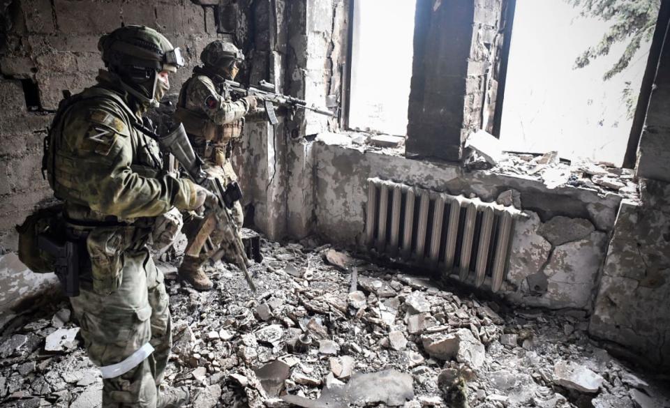 <div class="inline-image__caption"><p>Two Russian soldiers patrol in the Mariupol drama theater, bombed March 16, in Mariupol on April 12, 2022.</p></div> <div class="inline-image__credit">Alexander Nemenov/Getty</div>