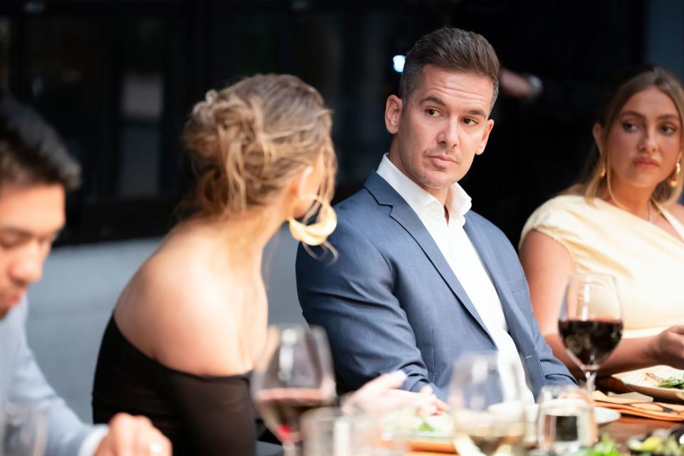 lauren and jono on married at first sight australia sit at a dinner table