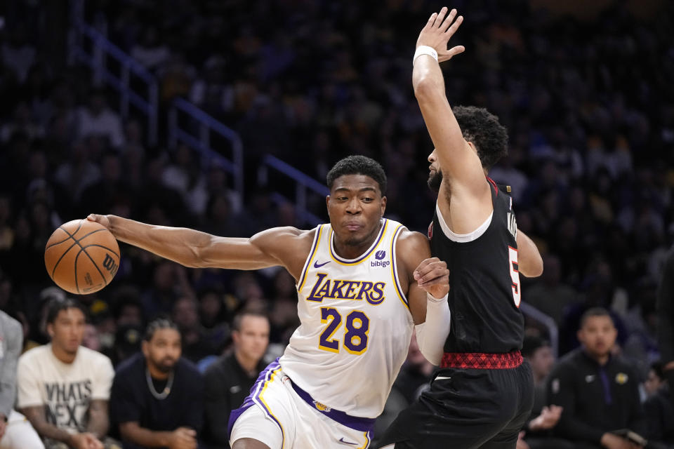 Los Angeles Lakers forward Rui Hachimura, left, drives past Portland Trail Blazers guard Skylar Mays during the first half of an NBA basketball game Sunday, Nov. 12, 2023, in Los Angeles. (AP Photo/Mark J. Terrill)