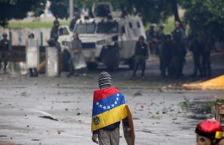 A demonstrator looks on while clashing with riot security forces during a rally against Venezuela's President Nicolas Maduro's government in Caracas, Venezuela, July 28, 2017. REUTERS/Carlos Garcia Rawlins