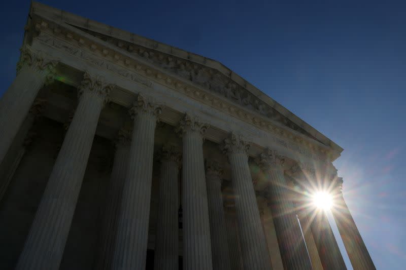 FILE PHOTO: The sun rises behind the U.S. Supreme Court building in Washington